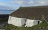 Gatliff Hebridean Hostel - Berneray turfed white cottage