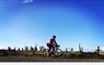 Skinny Tyres Ltd cyclist at Callanish Stones with blue sky