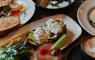 A table at HS1 Cafe Bar in the Royal Hotel, featuring plates of poached eggs, sourdough, and avocado.