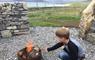 Na Bothain, Sandy Bay Wigwams ® boy at fire pit